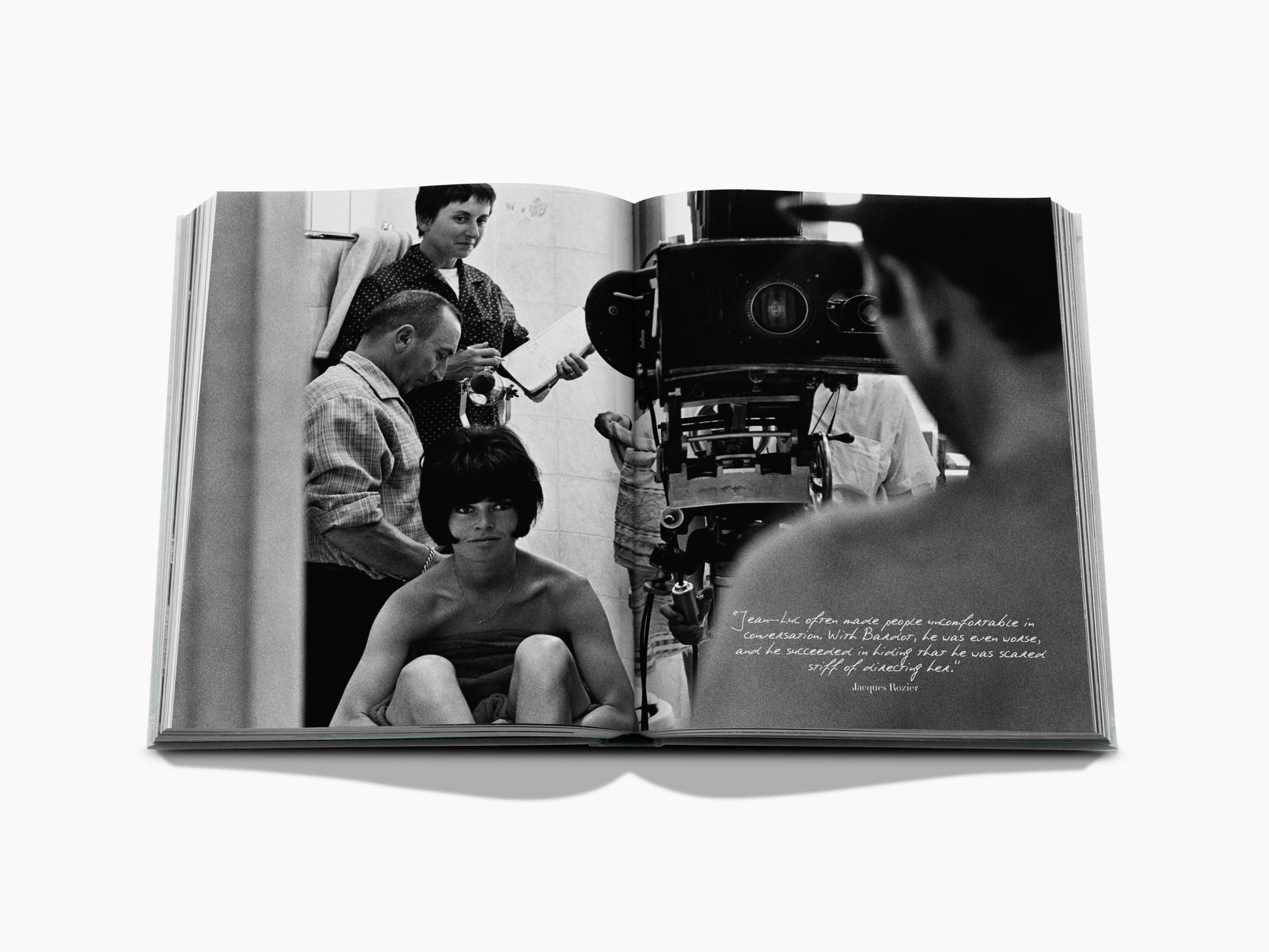 Opened Brigitte Bardot Intimate photo book shows a candid black and white moment with Bardot and a film crew.