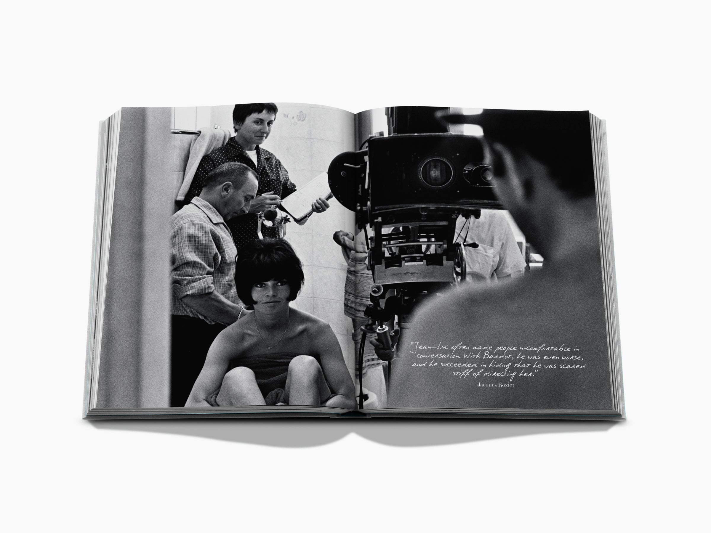 Opened Brigitte Bardot Intimate photo book shows a candid black and white moment with Bardot and a film crew.