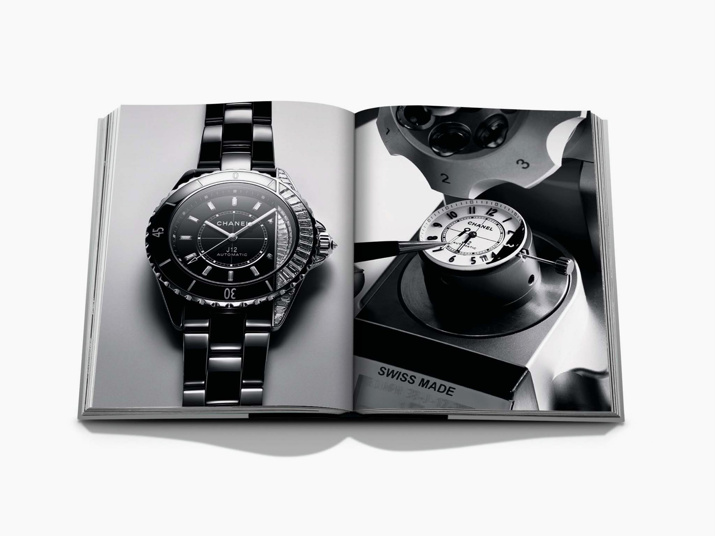 Open Chanel book slipcase spread with a stainless steel J12 watch on the left and a precision timepiece on the right