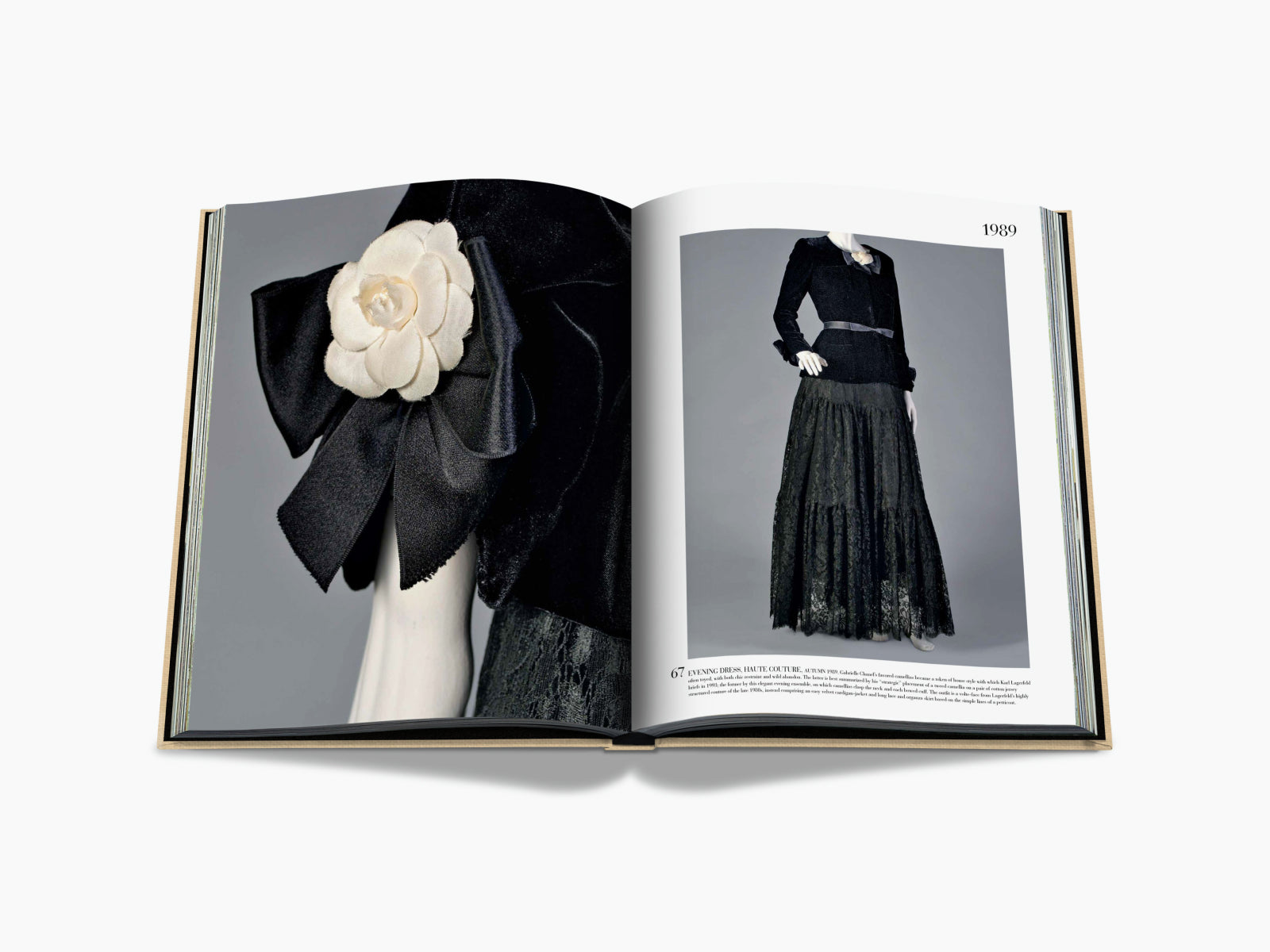 Chanel The Impossible Collection open to 1989 showing a black velvet dress with a white camellia and a lace evening gown.