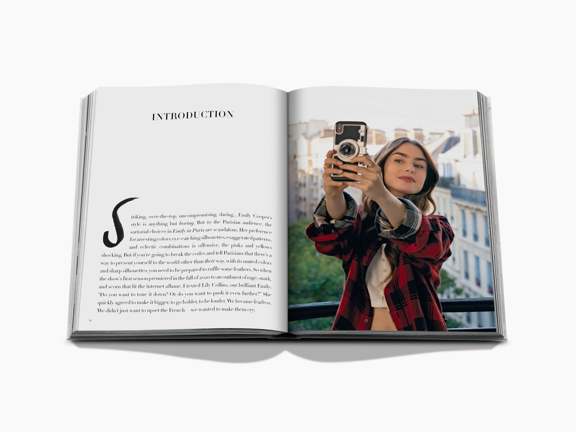 Spread from Emily in Paris Fashion Guide showing Introduction page and a woman with a vintage camera on a Paris balcony.