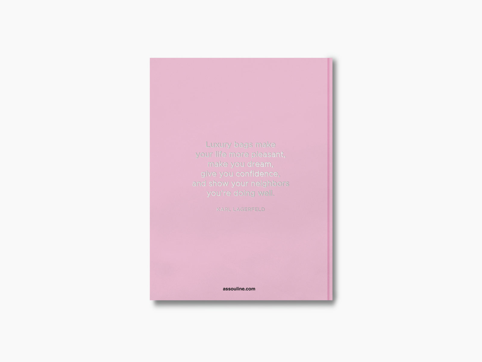 Pink book cover with a centered white quote about luxury bags and Assouline at the bottom