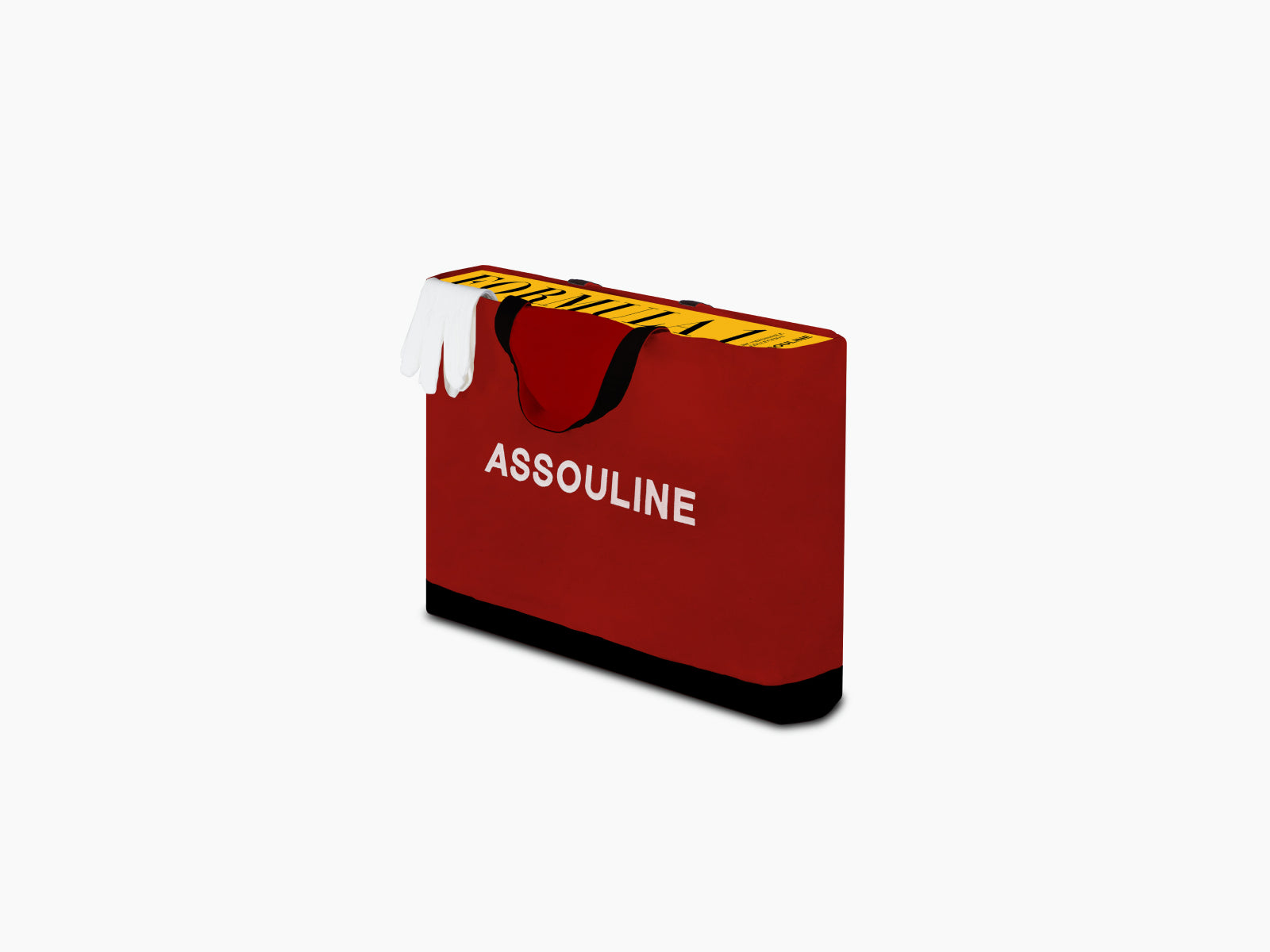 Red Formula 1 book resting in front of a yellow gift box with black interior, shown at an angled view