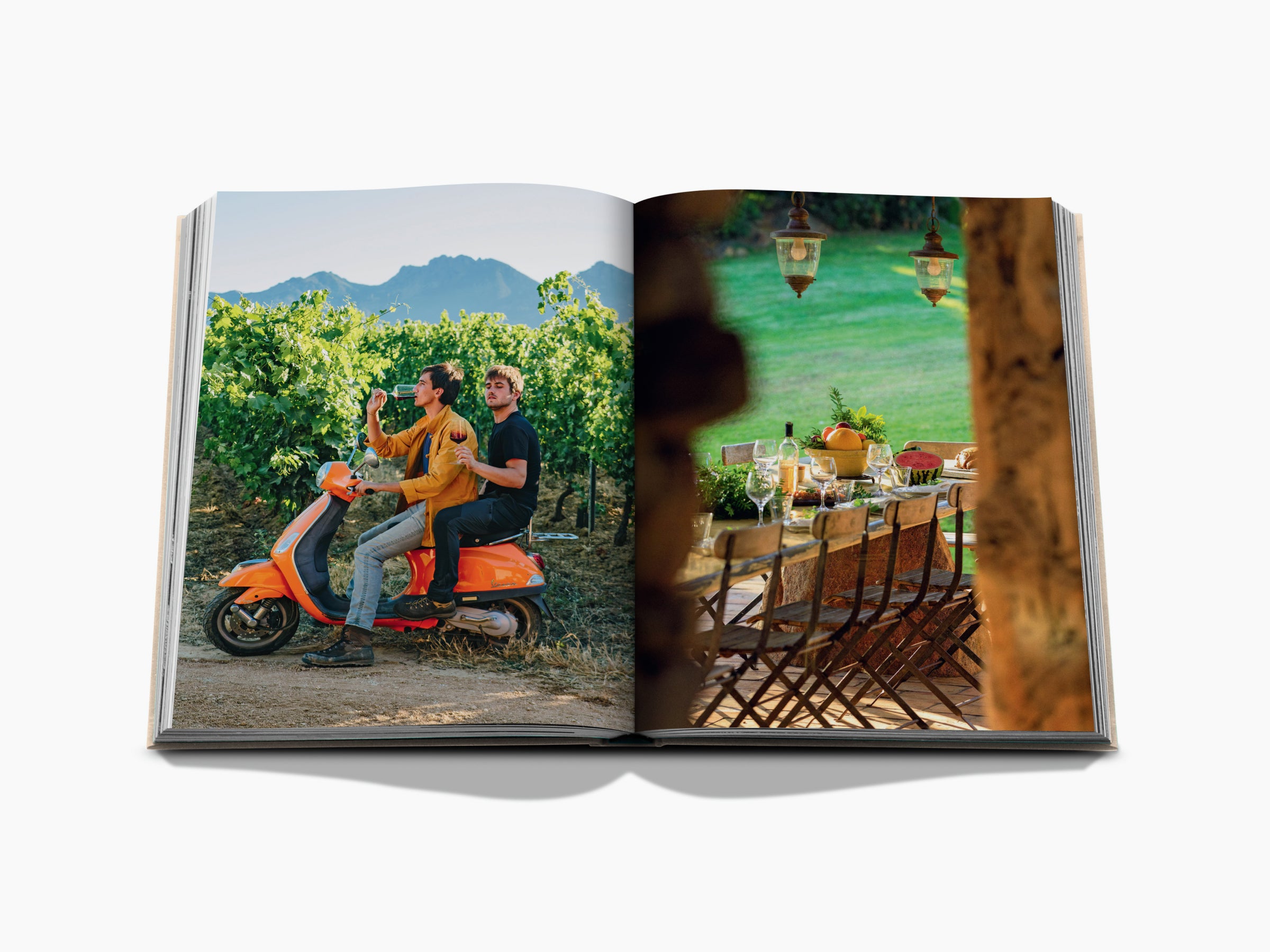 Open wine travel book with a vineyard scene of two men on an orange scooter on the left and a Corsica map and article on the right.