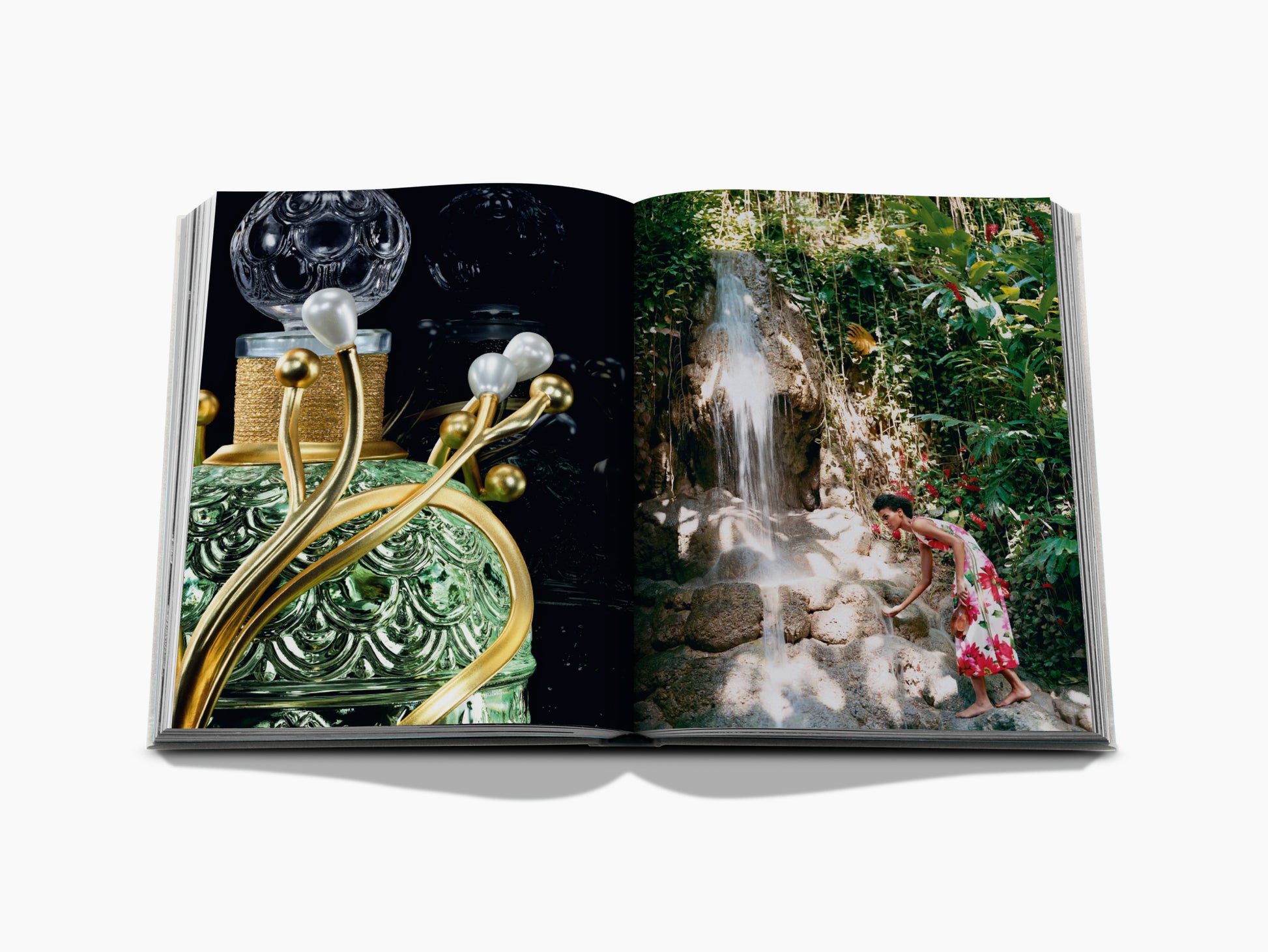 Left page close-up of an ornate perfume bottle; right page shows a woman in a floral dress by a tropical waterfall.
