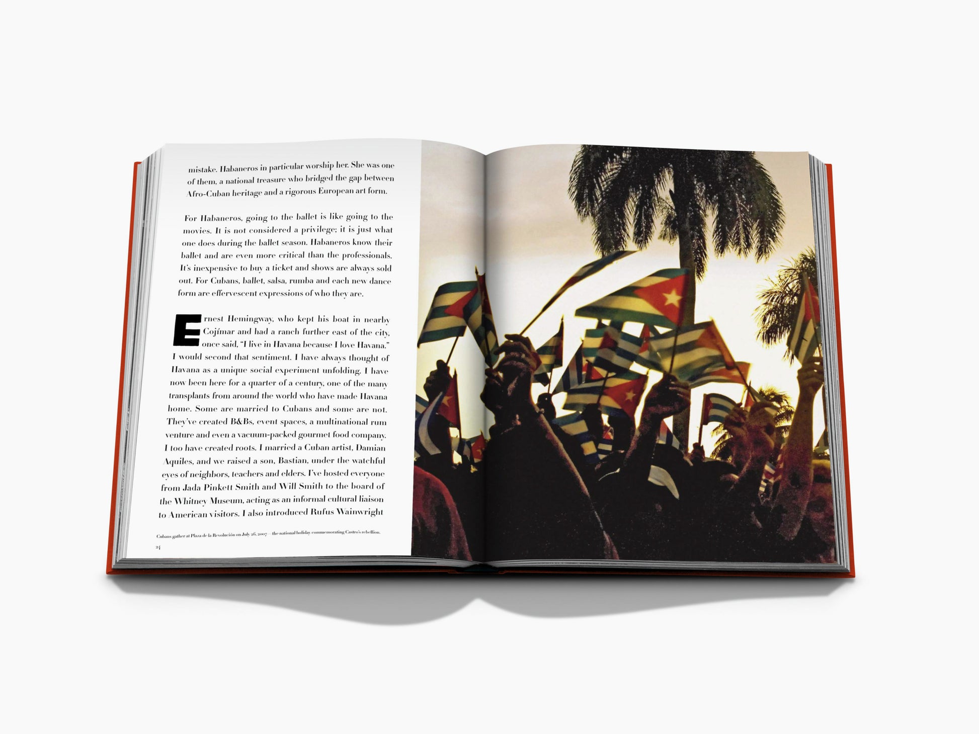 Open book spread with text on the left and a crowd waving Cuban flags among palm trees on the right.
