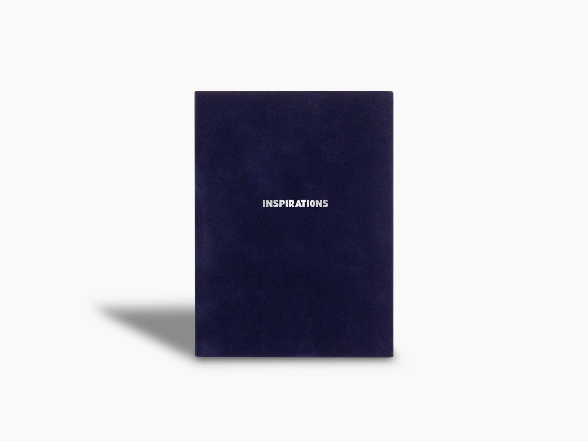Navy notebook cover with Assouline branding at the bottom.