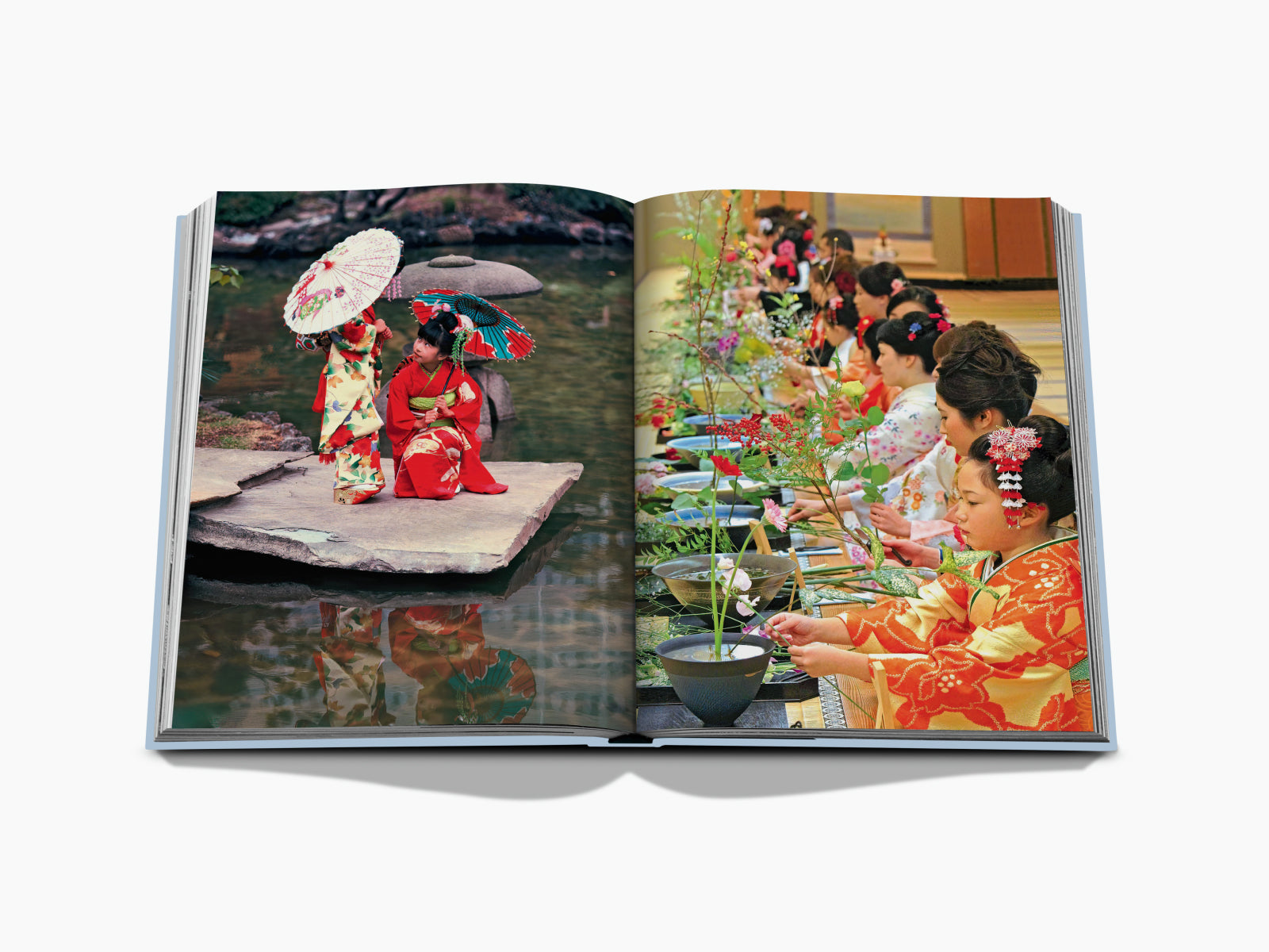 Two women in vibrant kimonos stand on a platform with a market backdrop