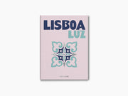 Lisboa Luz book cover with pink linen texture, bold dark blue LISBOA and mint LUZ beside a decorative tile motif.
