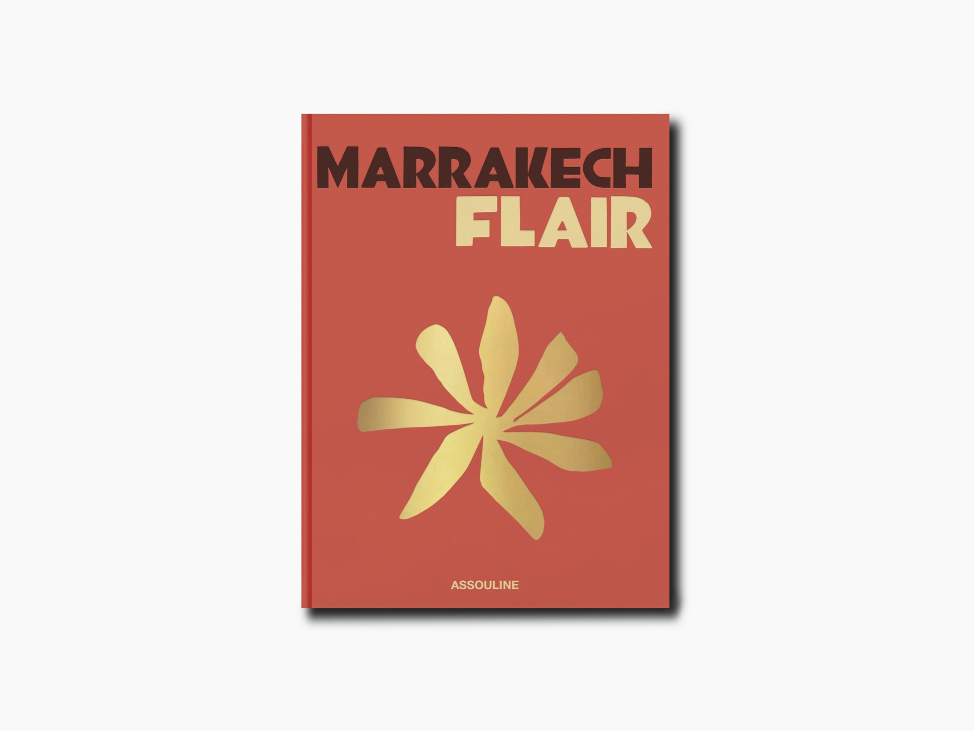 Marrakech Flair book cover with bold title and a yellow flower motif on a warm red-orange background