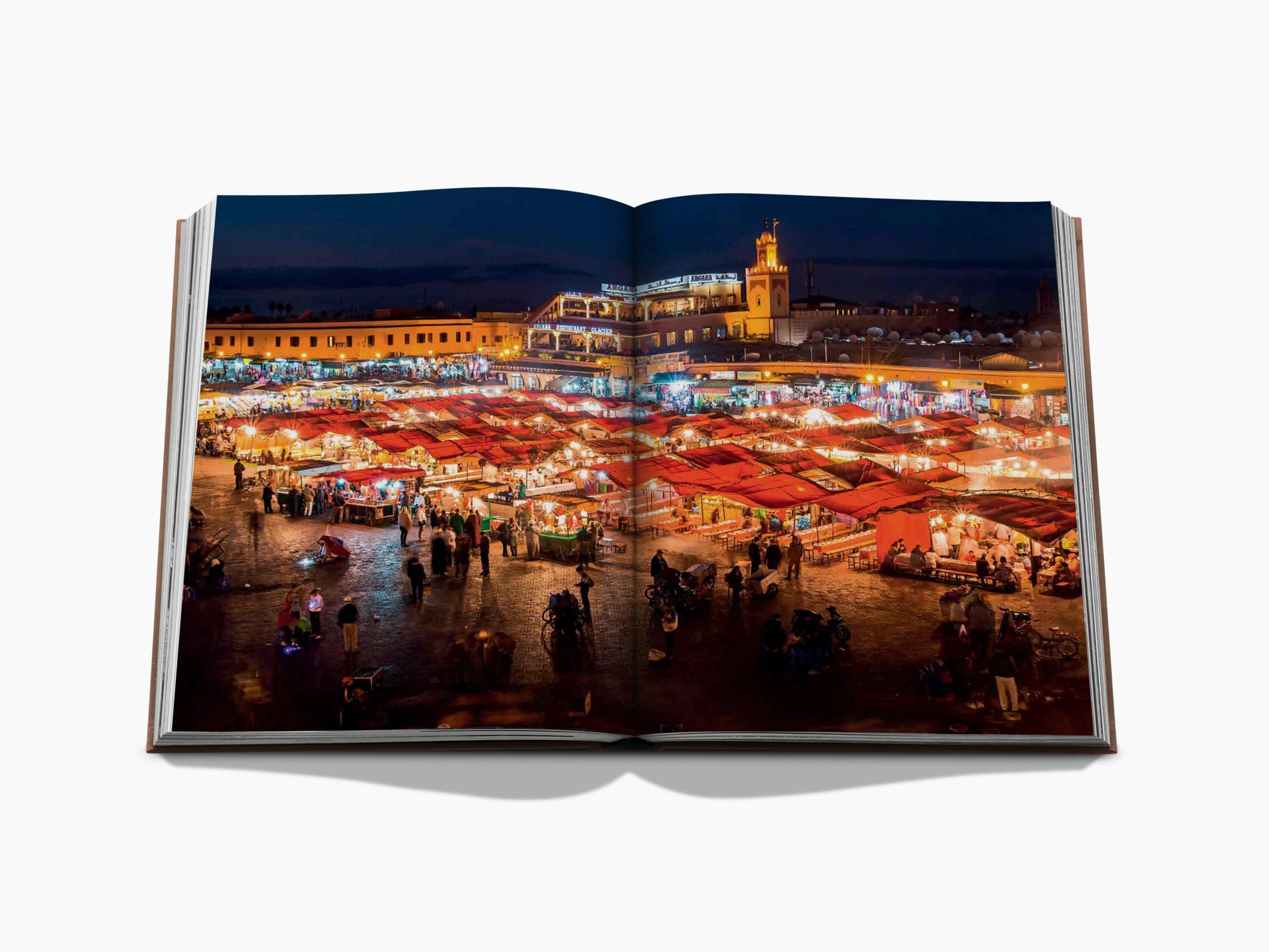 Bustling Marrakech night market with illuminated stalls and red canopy awnings