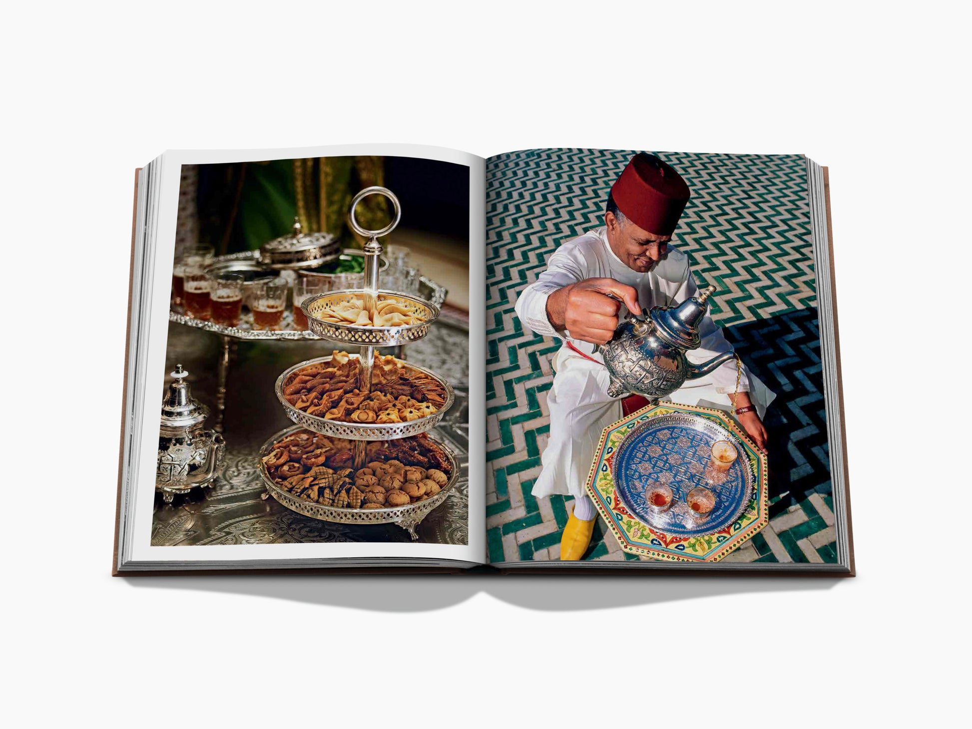 Two page Marrakech Flair spread with a tiered tray of sweets on the left and a man in a fez pouring tea on the right.