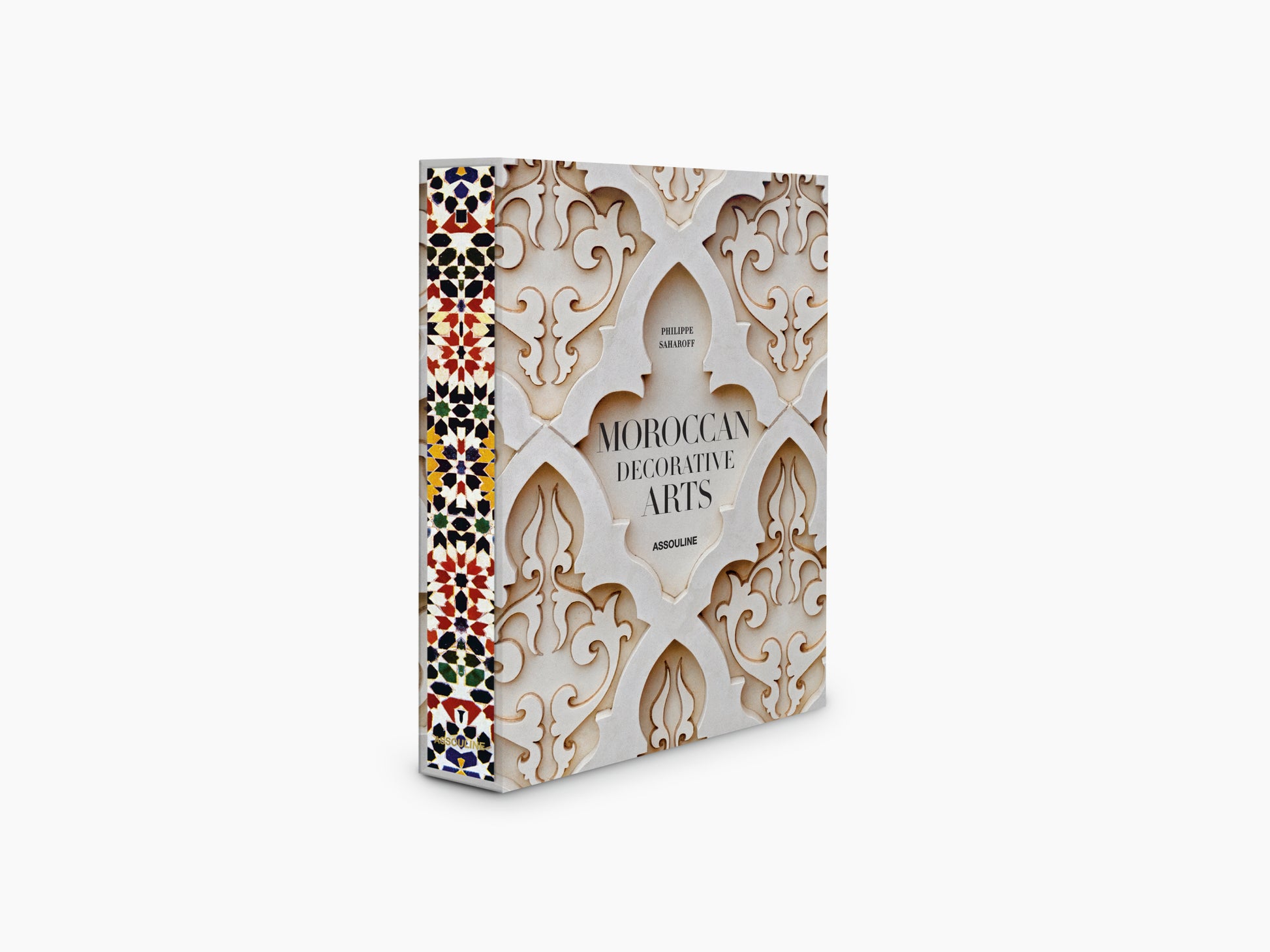 Moroccan Decorative Arts book angled to show cream plaster pattern and a vivid mosaic strip along the left edge.