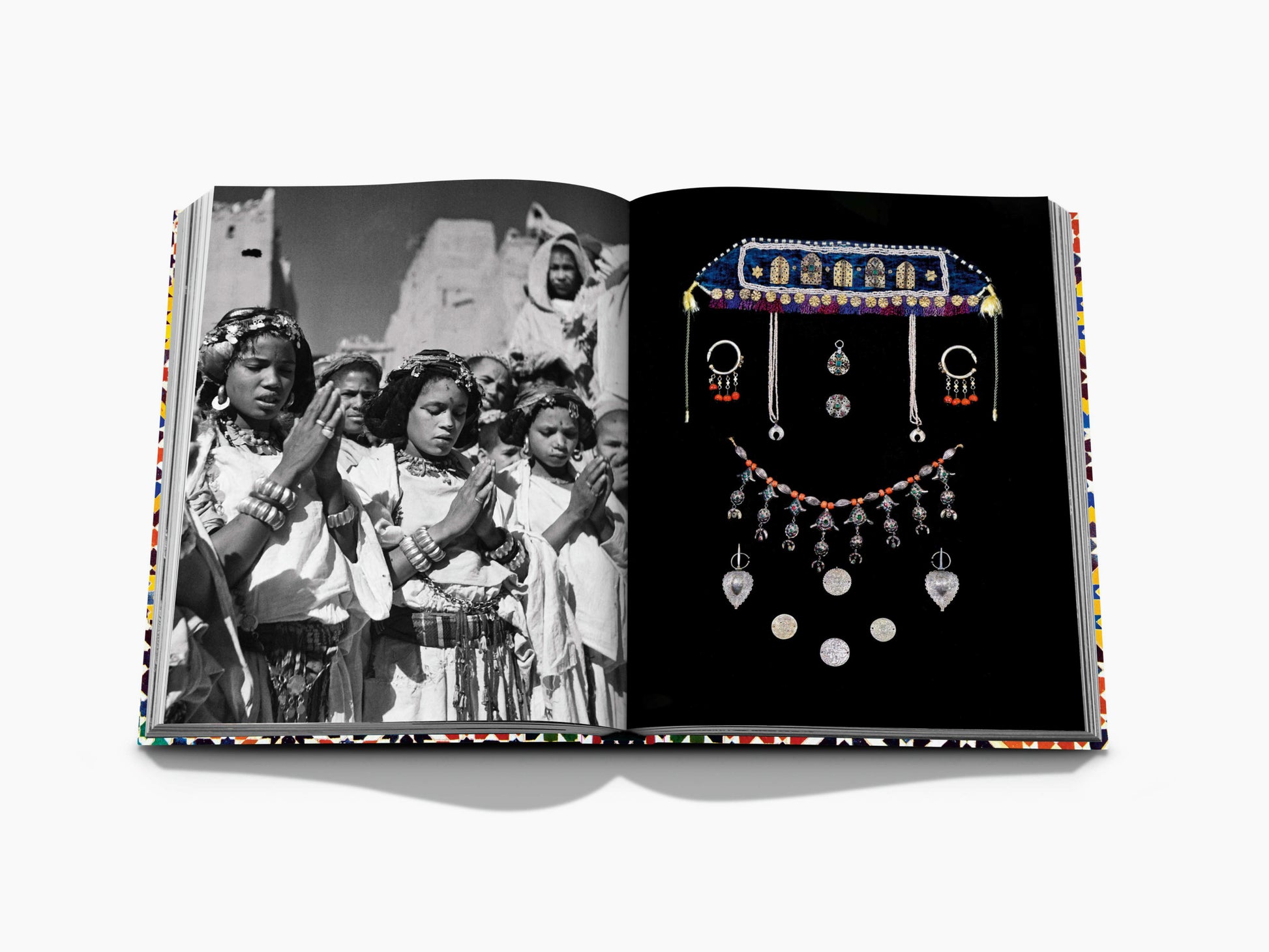 Open spread with a black and white scene of women in traditional dress on the left and an ornate jewelry display on the right.
