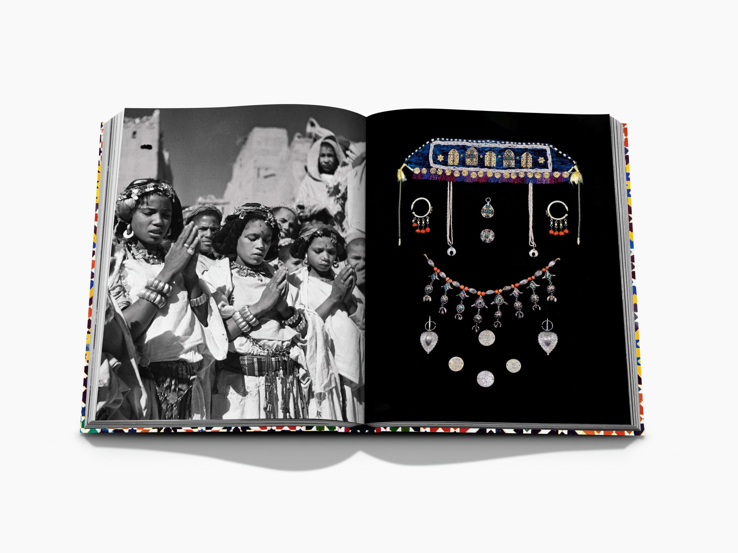Open spread with a black and white scene of women in traditional dress on the left and an ornate jewelry display on the right.