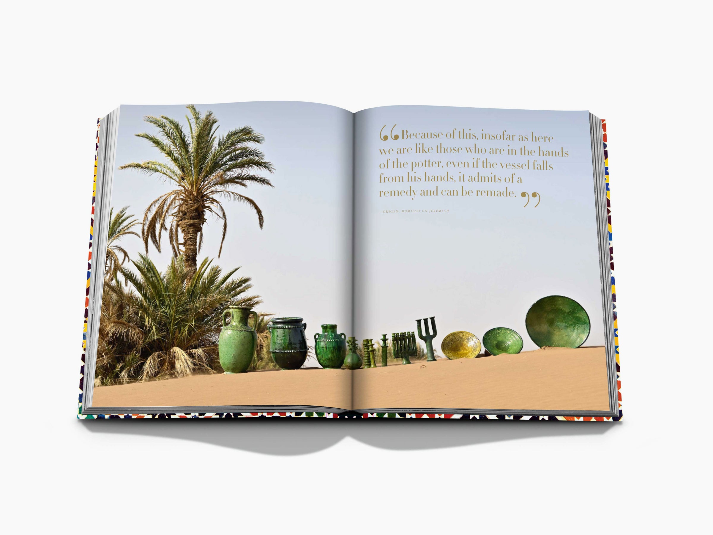 Desert spread with palm trees and a row of green pottery along the sand across two pages with a gold quote.