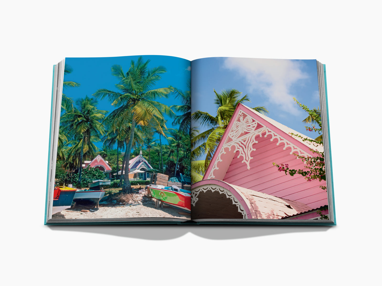 Palm trees frame a colorful Caribbean beach village with boats on the shore and pastel cottages under a clear blue sky
