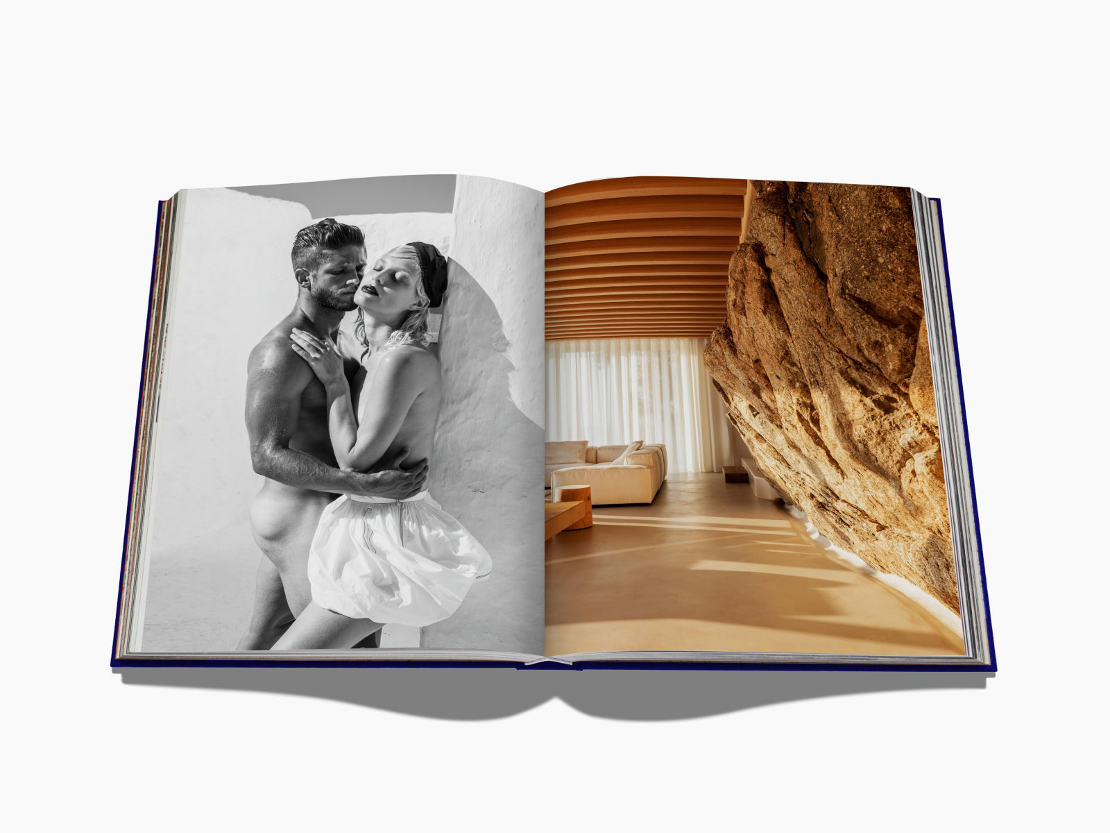 Open book spread showing a black-and-white couple embracing on the left and a sunlit rock-walled living room on the right.