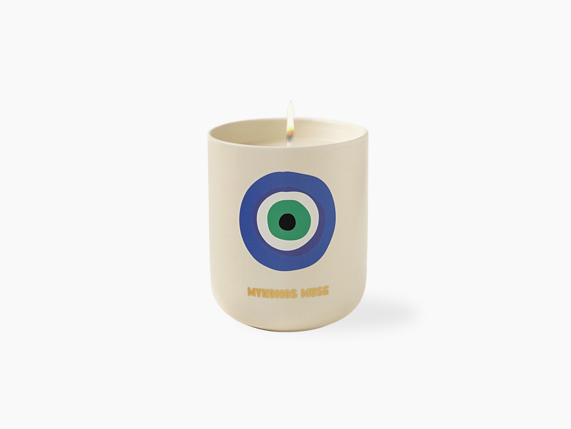 Close-up of a cream Mykonos Muse candle with the blue circular logo and the matching navy box beside it