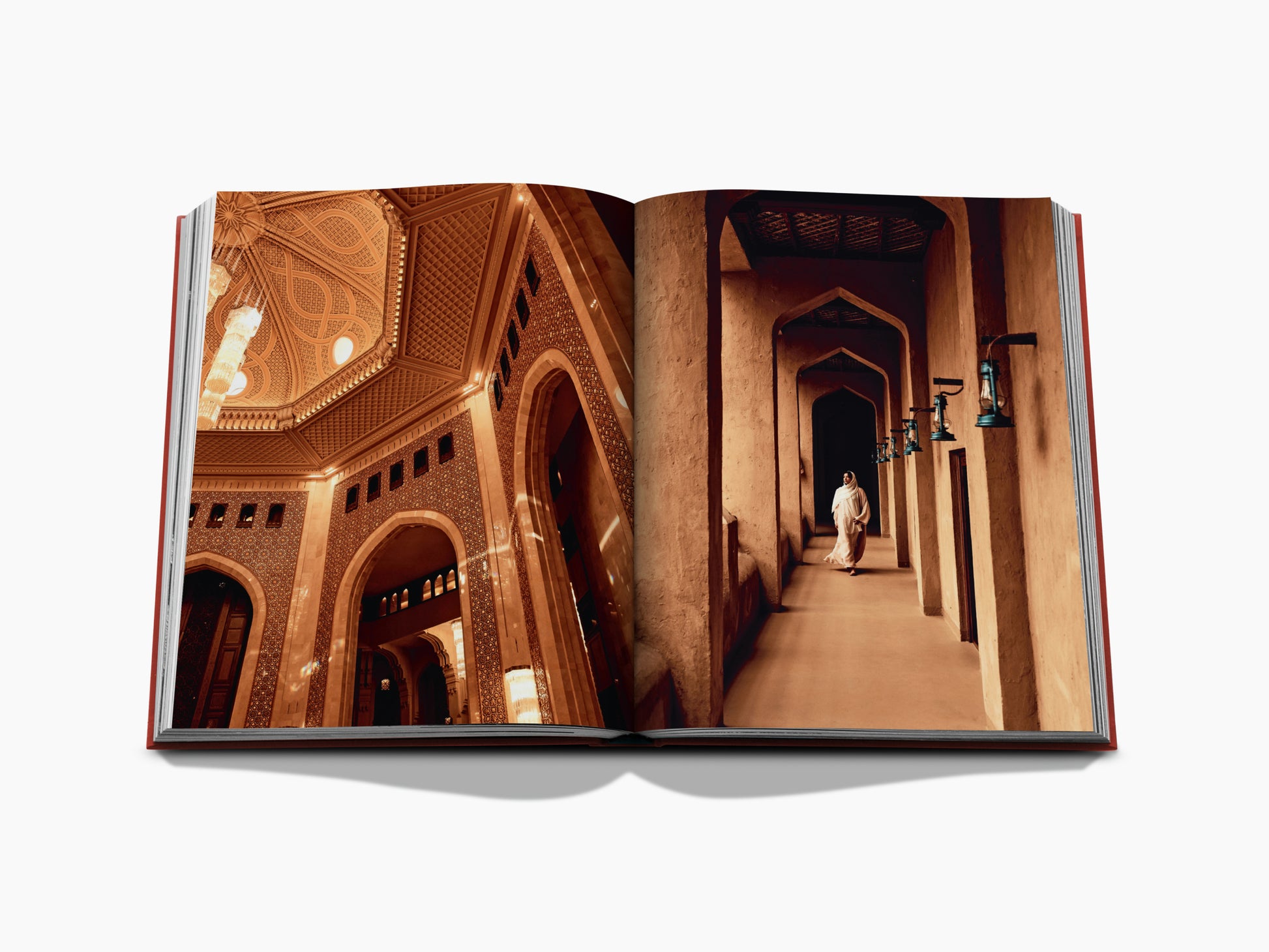 Open book spread showing ornate arches and a sunlit corridor with a person walking on the right page.
