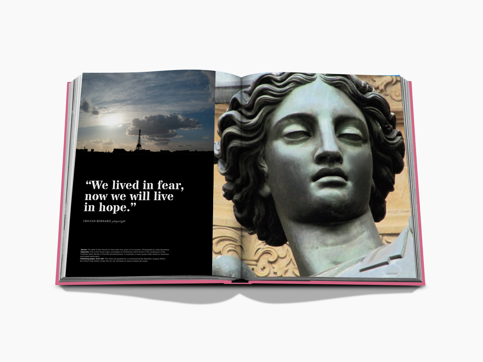 Open book spread showing a sunset cityscape with the Eiffel Tower on the left and a large statue head on the right.