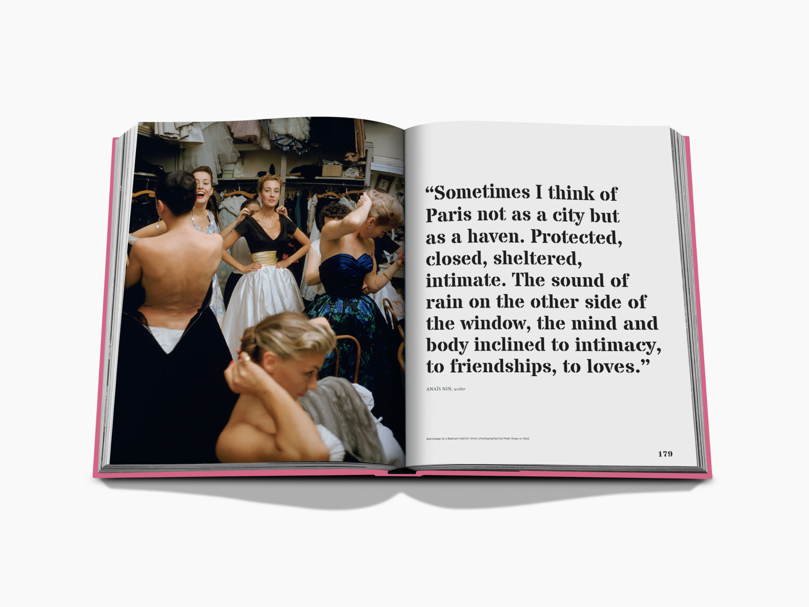 Backstage at a fashion show with models in glamorous gowns and assistants adjusting outfits.