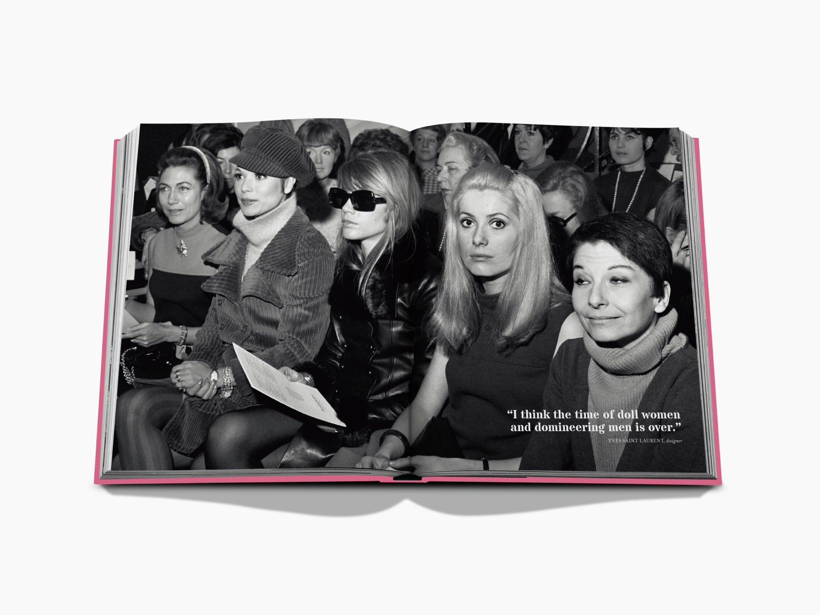 Open book spread featuring a black and white fashion show audience and a bold quote on the page.