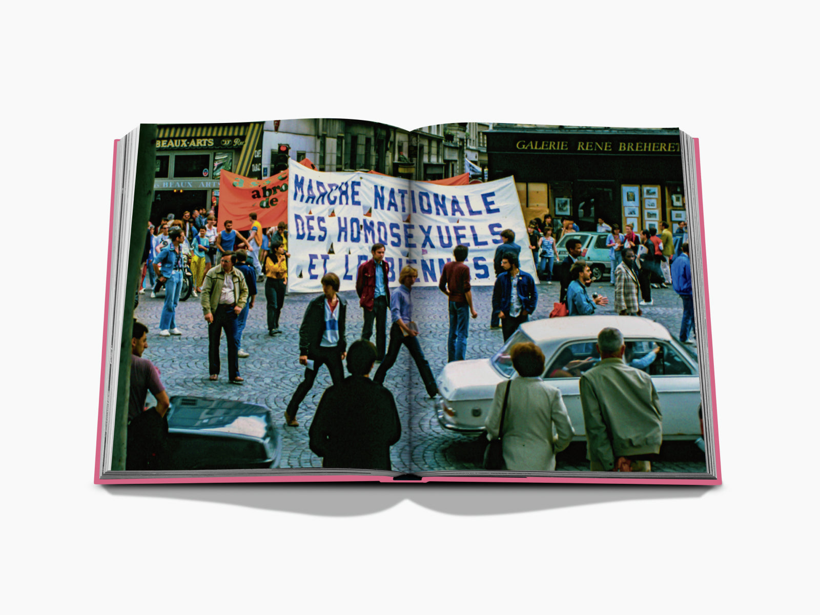 Open Paris by Paris book page showing a Paris street protest with a large banner.