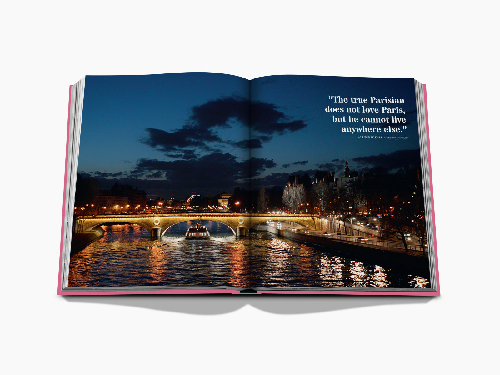 Open Paris by Paris book page featuring a nighttime Seine river view with a lit bridge and a quotation.