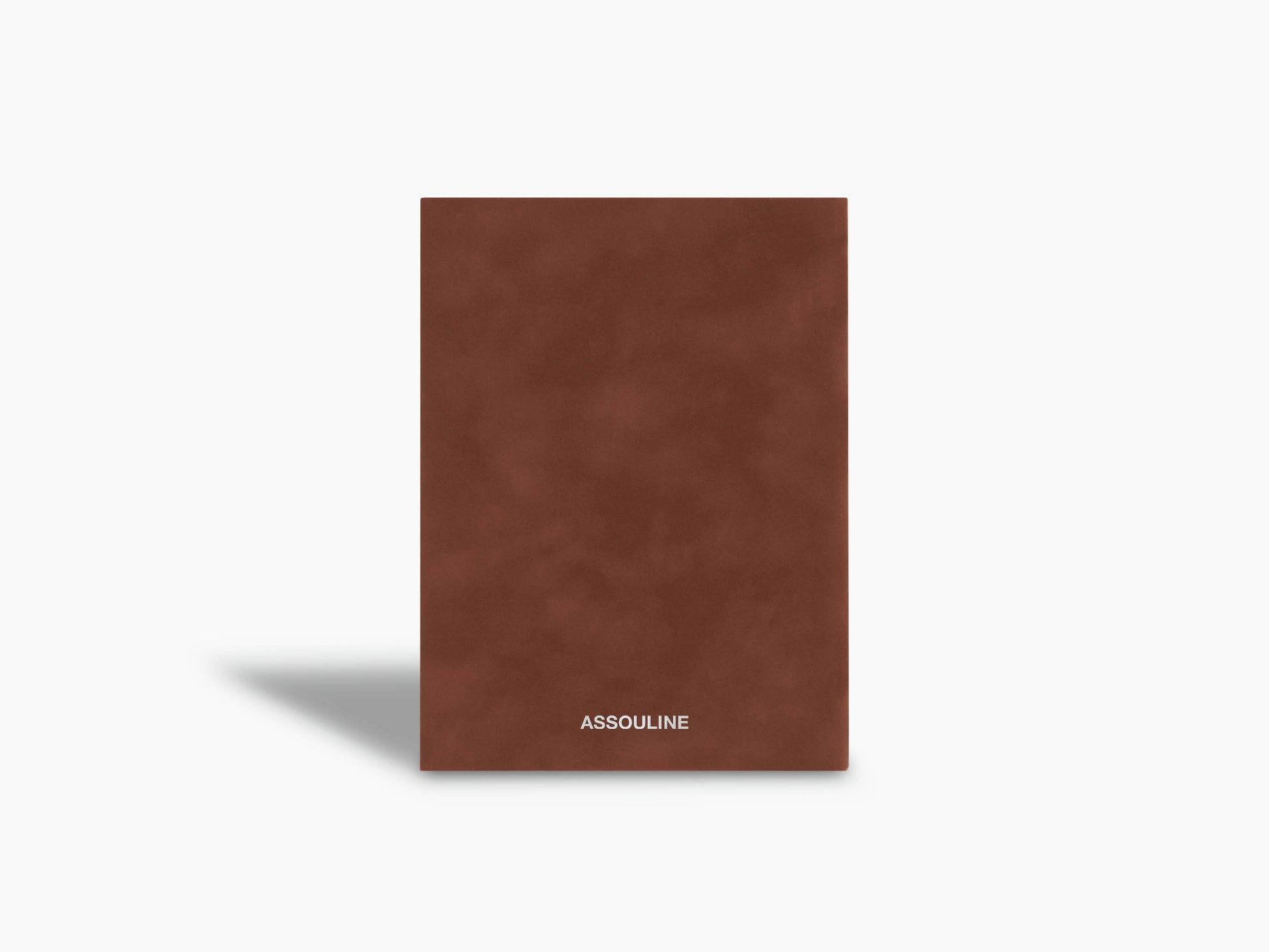 Brown suede Scandals notebook with a small white Assouline logo at the bottom