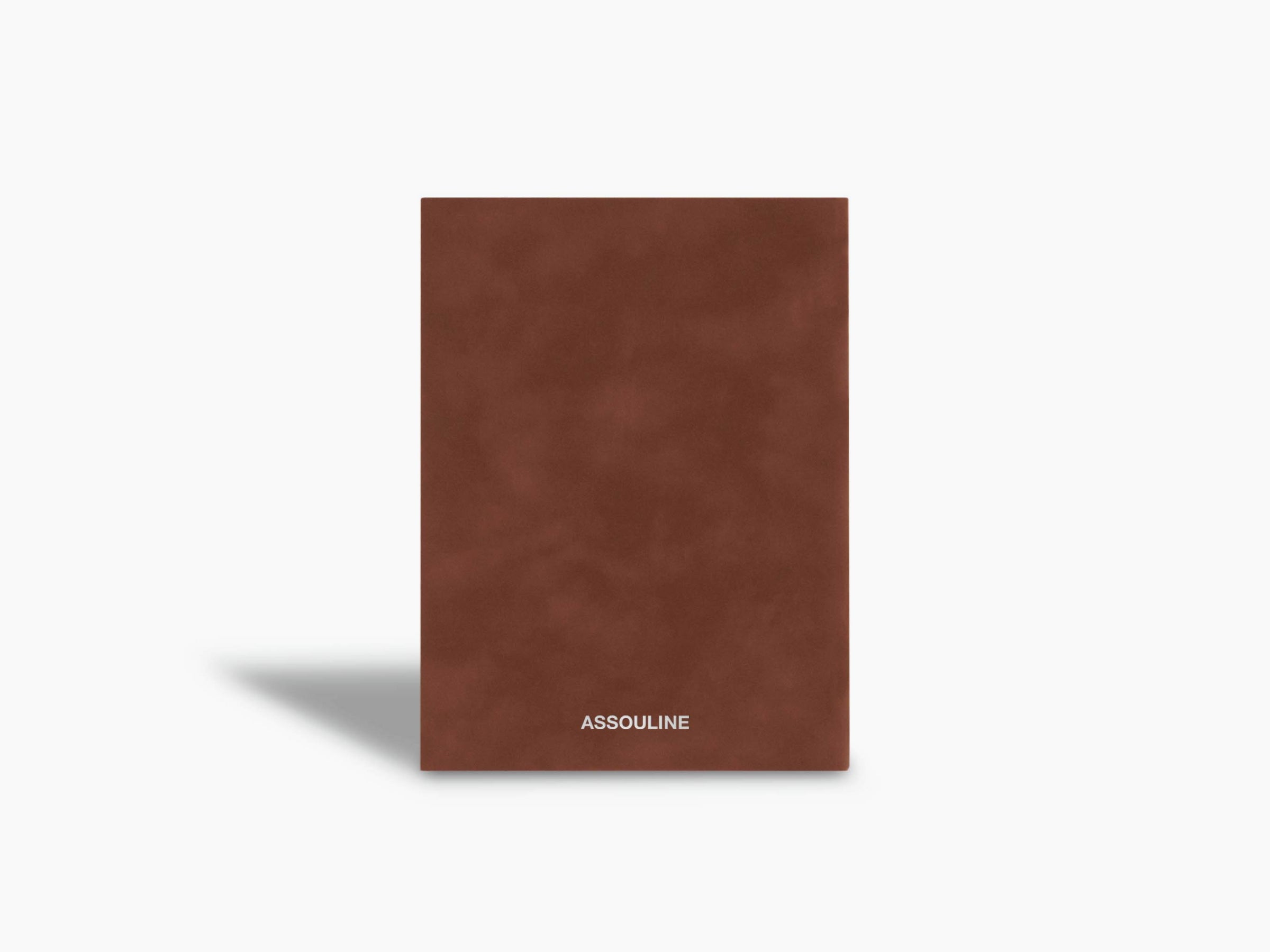 Brown suede Scandals notebook with a small white Assouline logo at the bottom