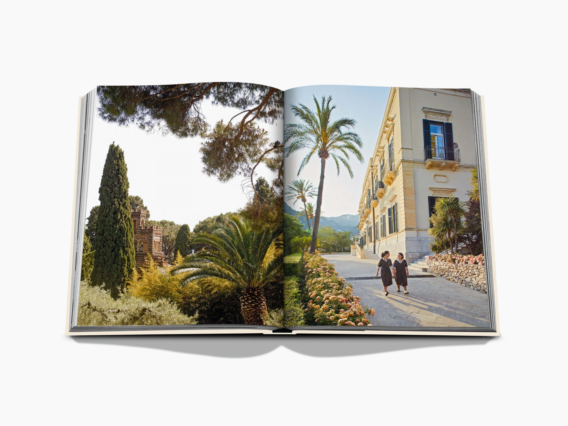 Open book spread showing Taormina garden with palm trees on the left and a pale villa with two people strolling on a stone path on the right.