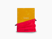 Open orange Temptations notebook with a red elastic closure and lined pages