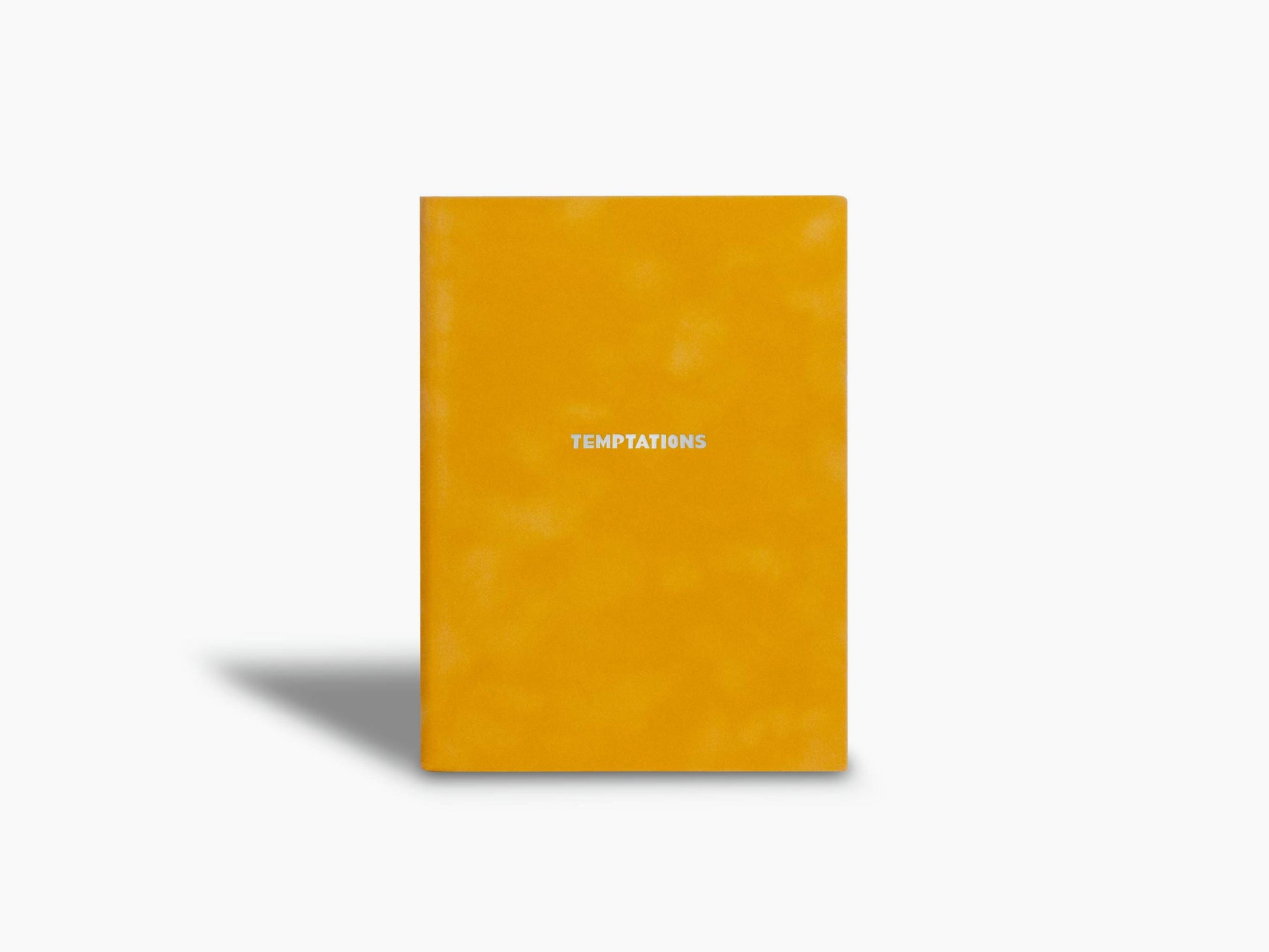 Bright orange suede Temptations notebook with a centered white title on the cover