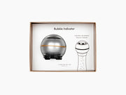 Bubble Indicator pressure device for sparkling wine shown in its box with the device and diagram.