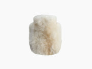 Creamy white alpaca wrapped hot water bottle CALMO 0.6L shown in close up.