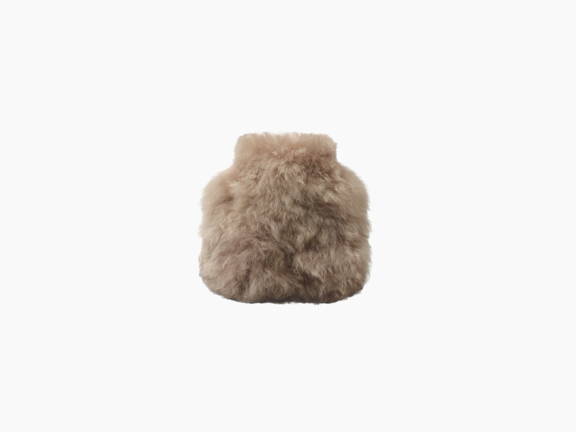 Beige fluffy hot water bottle wrapped in soft alpaca fur seen from the front