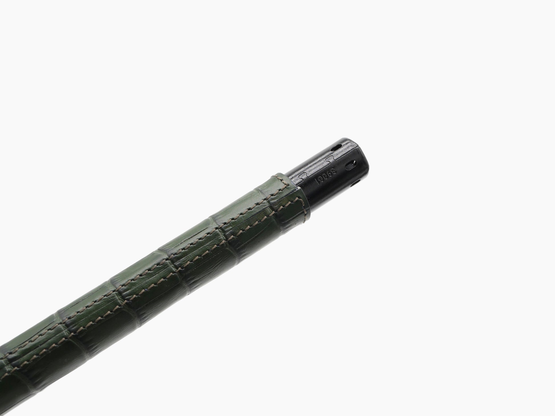 Diagonal view of the same green leather wrapped lighter with black metal tip