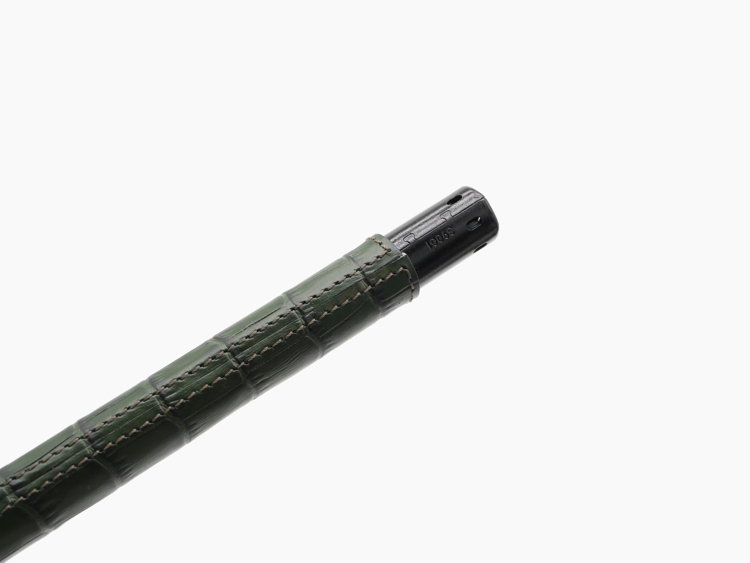 Diagonal view of the same green leather wrapped lighter with black metal tip