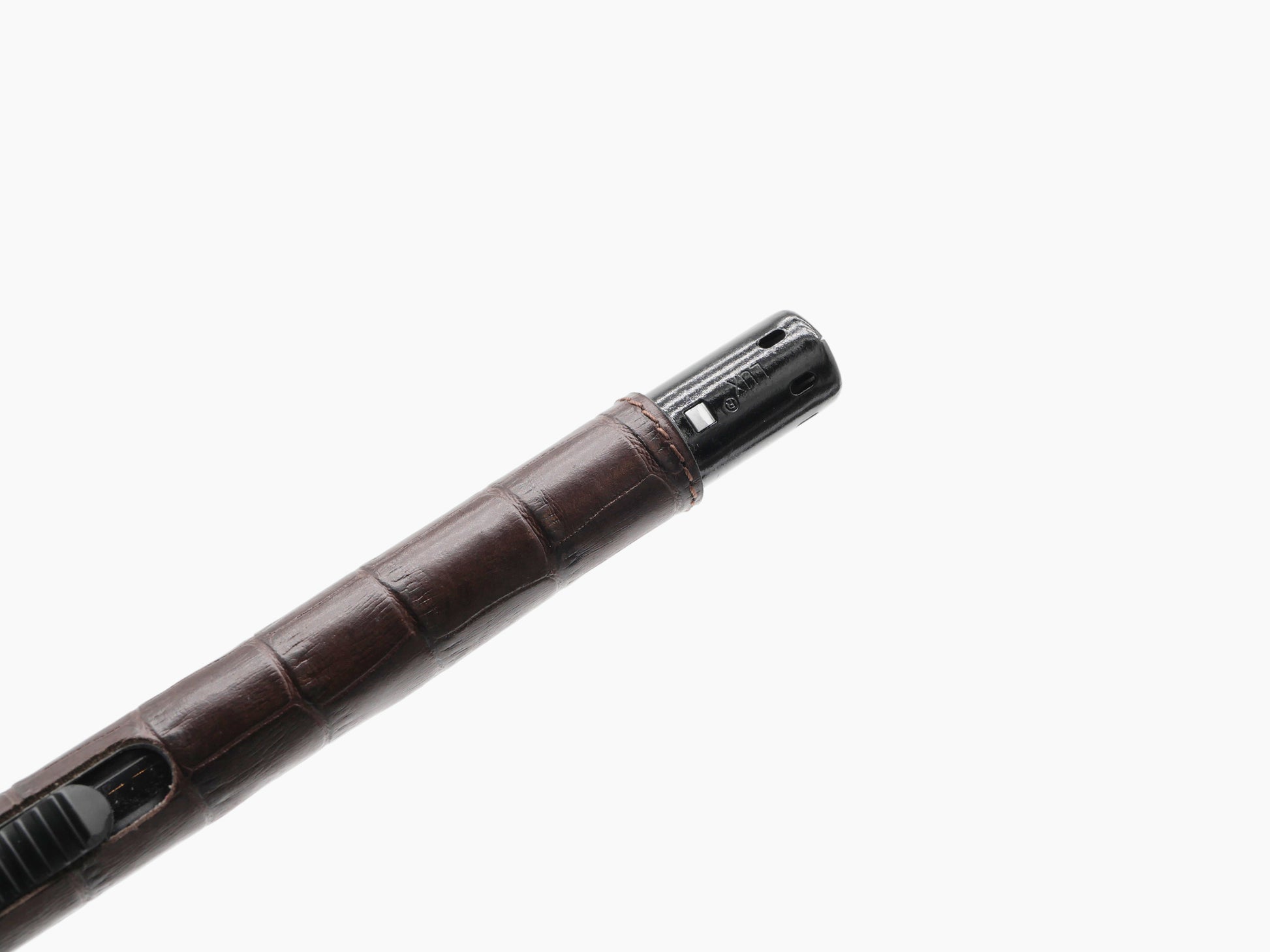 Close-up of the lighter head with black metal end and ignition slot.