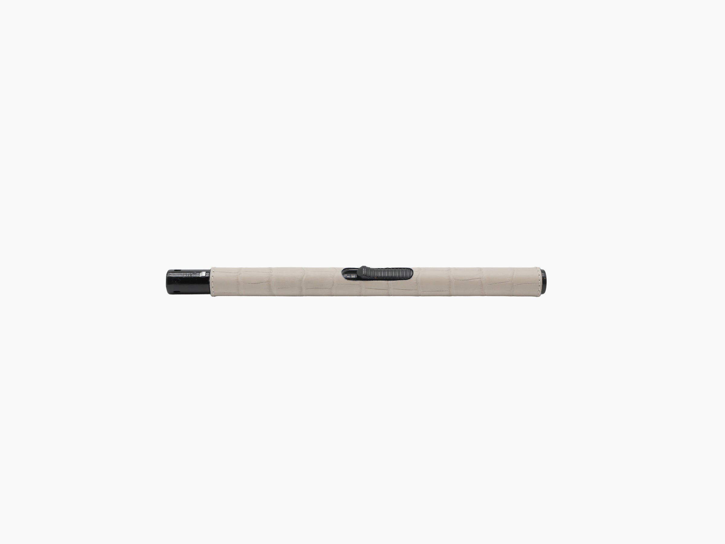 Slim metal lighter with beige leather wrap and black end cap against a white background