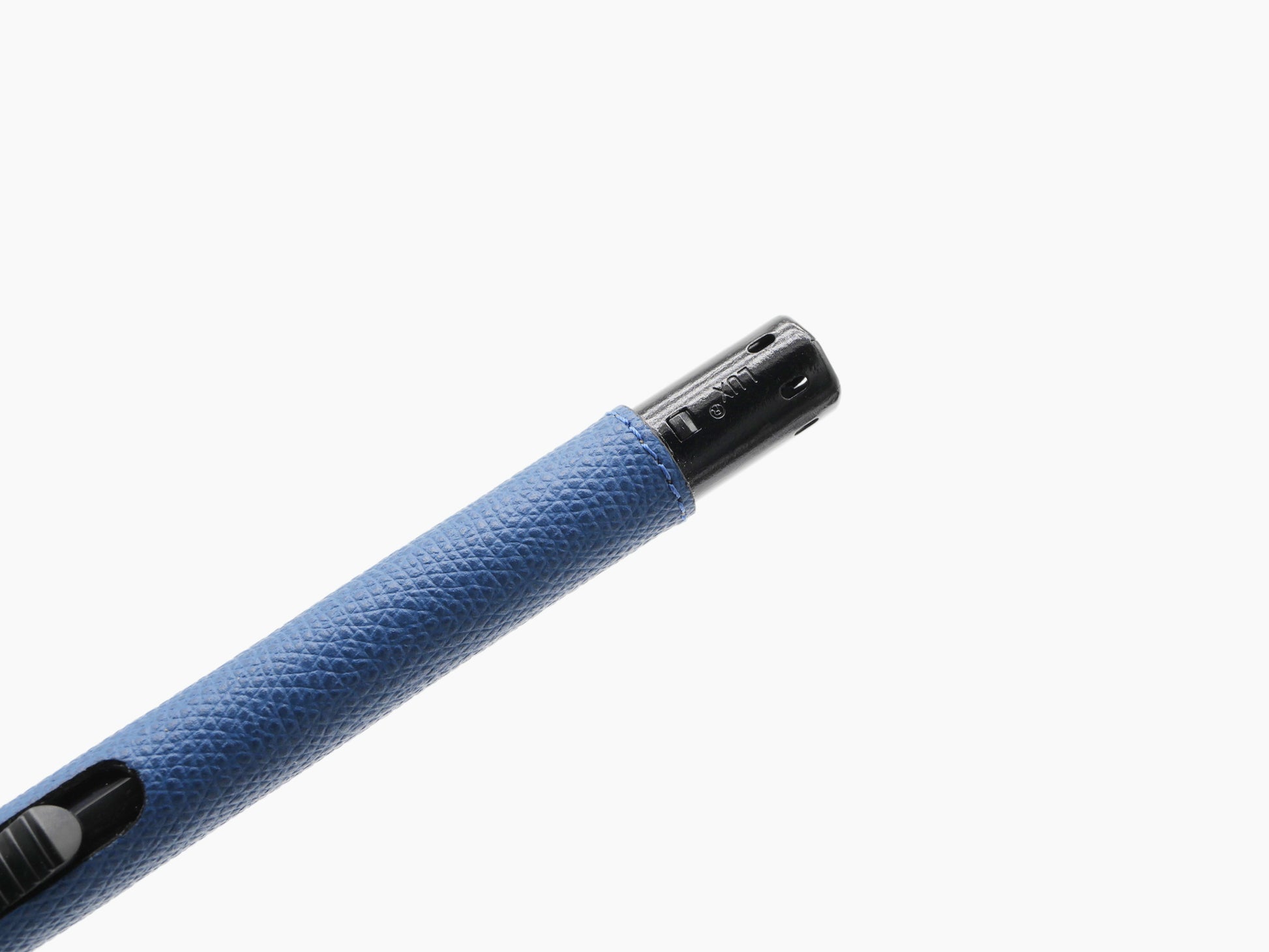 Close-up of blue leather wrapped candle lighter head showing black metal nozzle