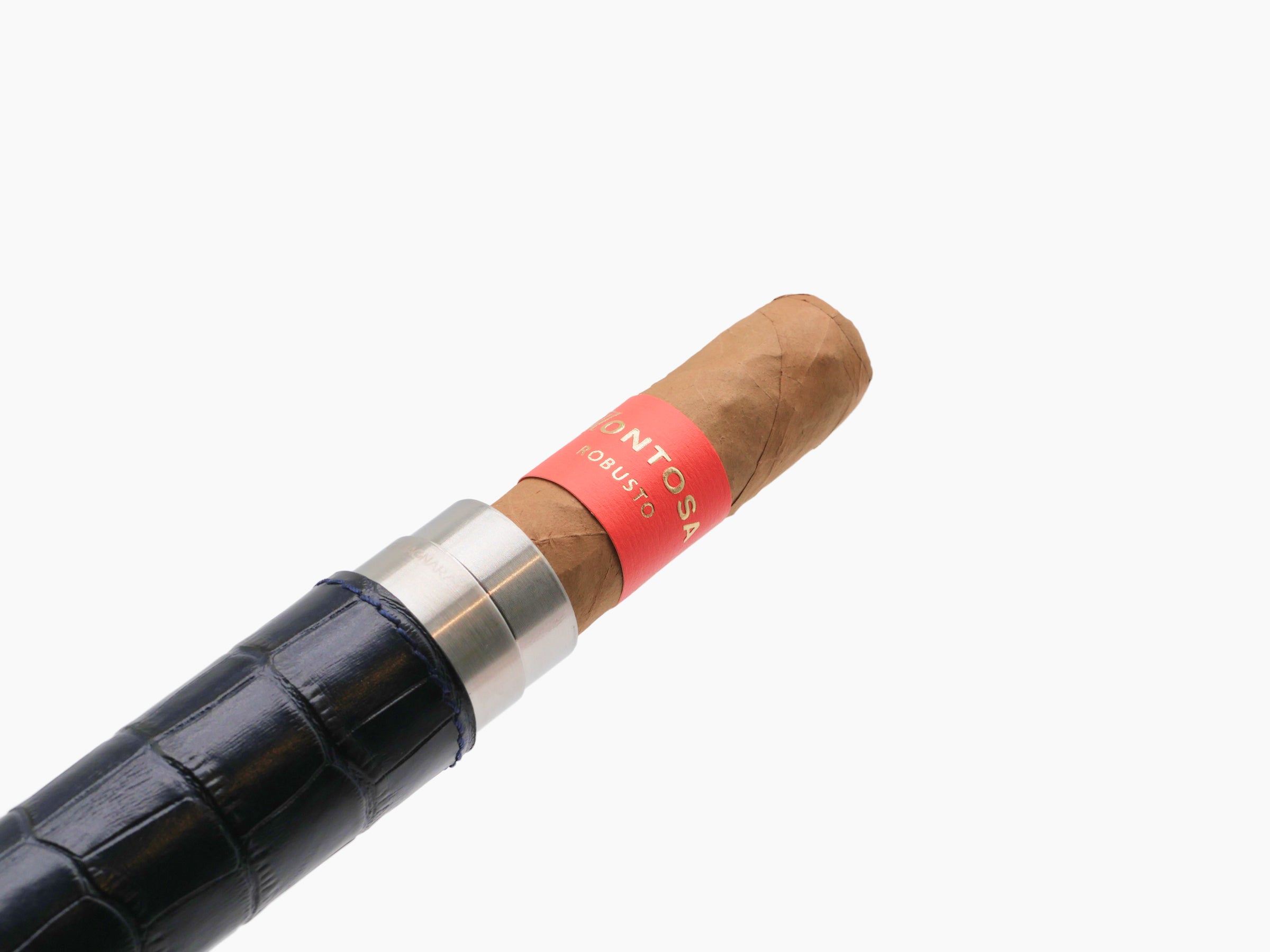 Close-up of a brown cigar in a silver metal holder with a black textured leather wrap and a red band.