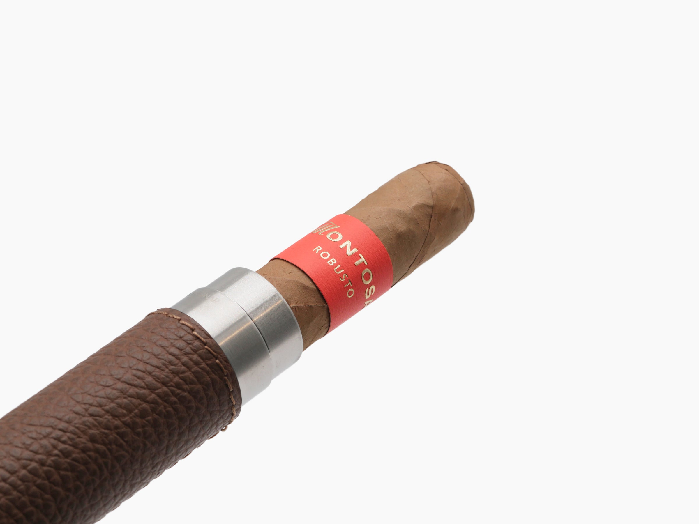 Macro view of a cigar in a black leather wrapped holder with a metal collar and red band around the cigar.
