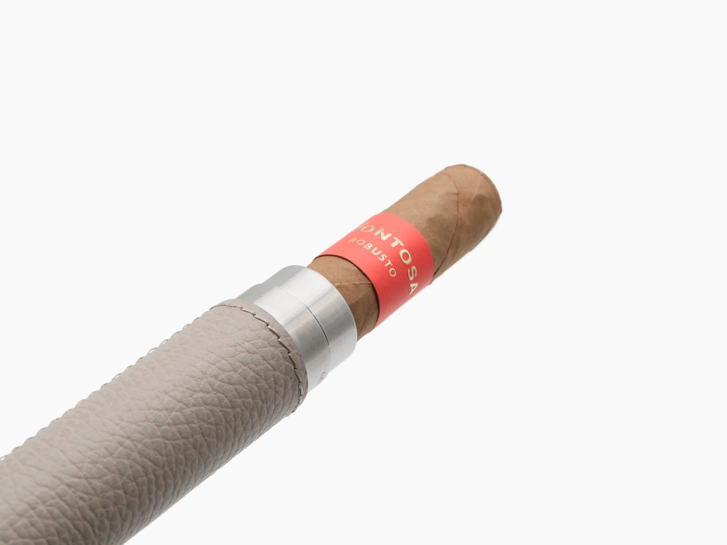 Close up of beige leather wrapped cigar holder with a silver end cap and a nearby cigar with a red band.