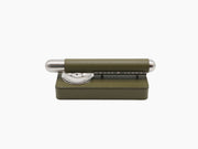 Olive green cigar holder set with chrome ashtray and matching leather case; a cigar rests on the ashtray