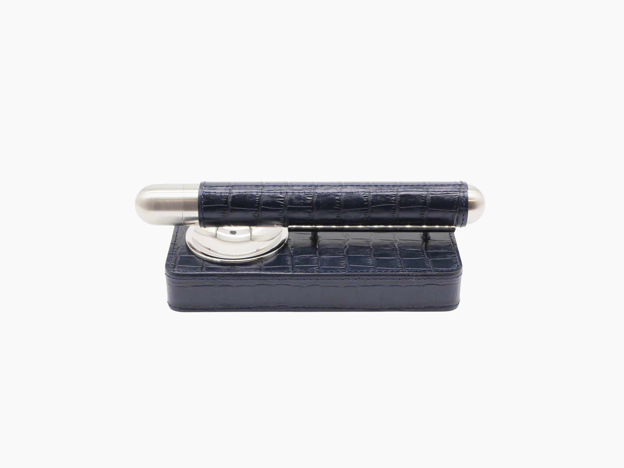 Cigar holder resting across a royal blue leather case.