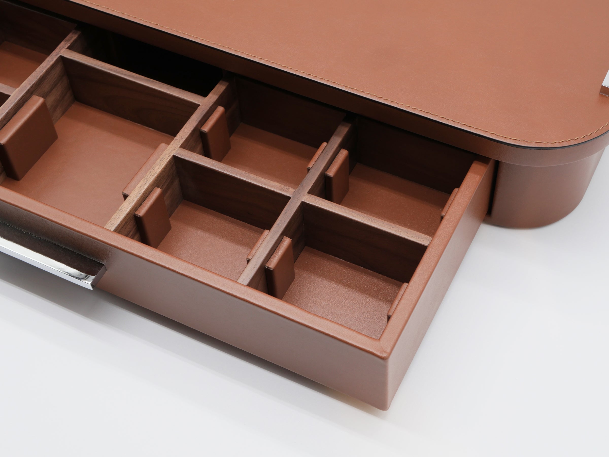 Angle view of the leather coffee organizer drawer partially pulled out showing segmented internal compartments