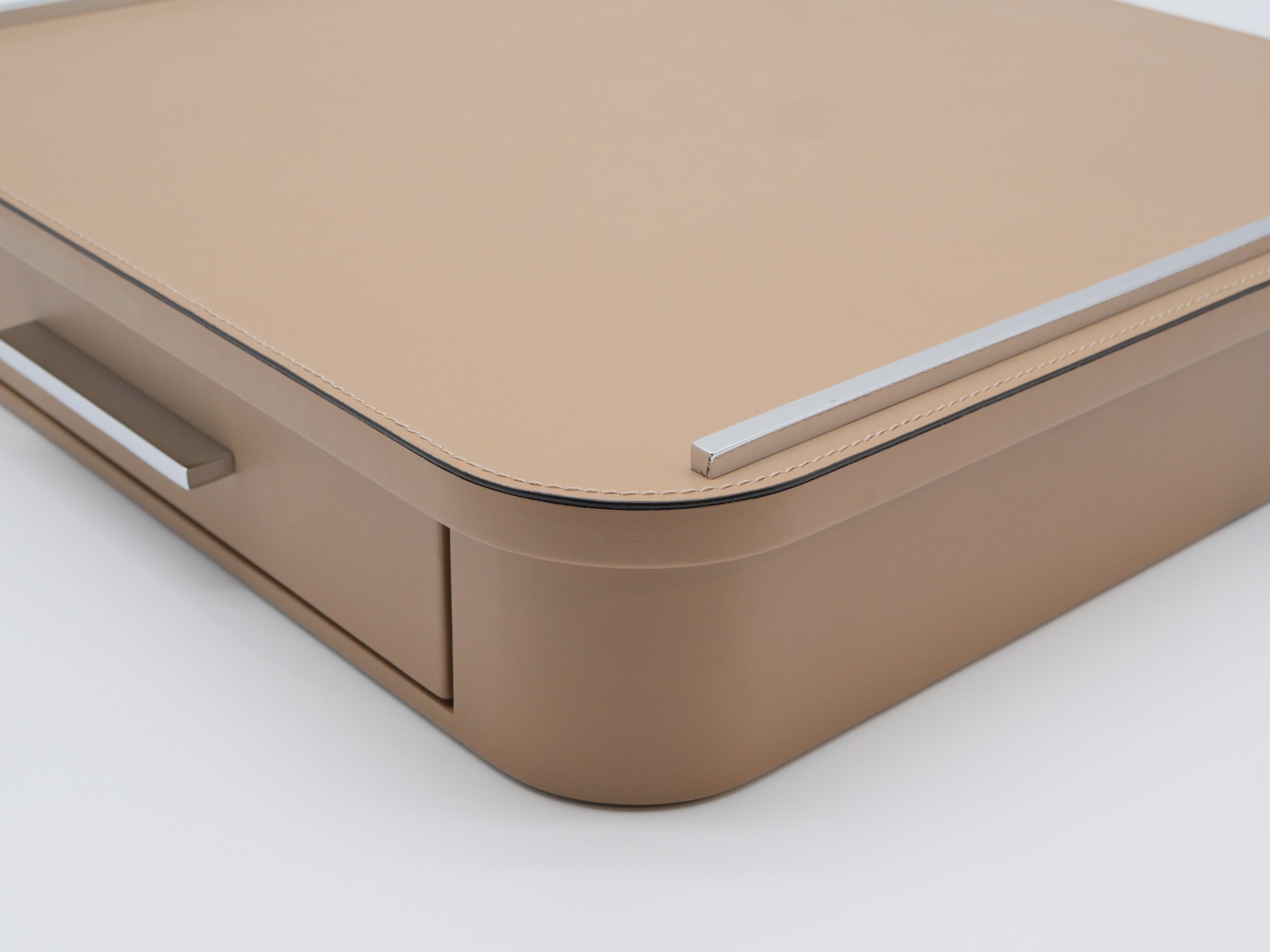 Corner view of Saint–Germain Classic Capsule Drawer in tan leather with a marble top and chrome rail.