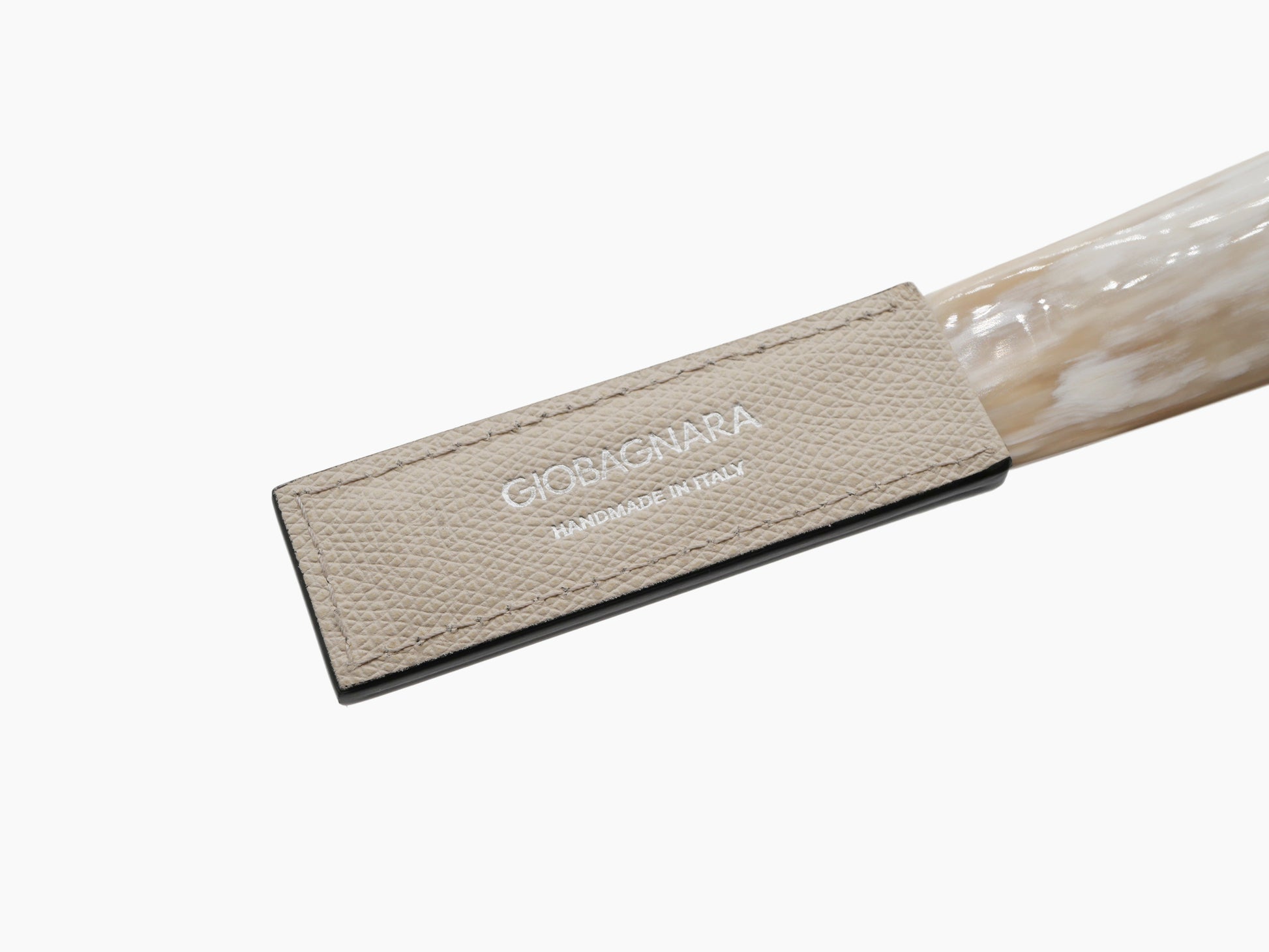 Leather GioBagnara tag on the Corno Shoehorn beside the horn, handmade in Italy